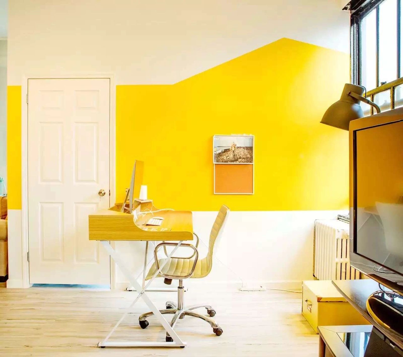 A desk against the yellow wall