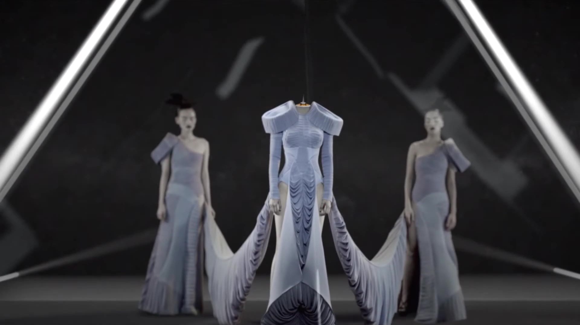Sculptural gowns composed in a graphic set.