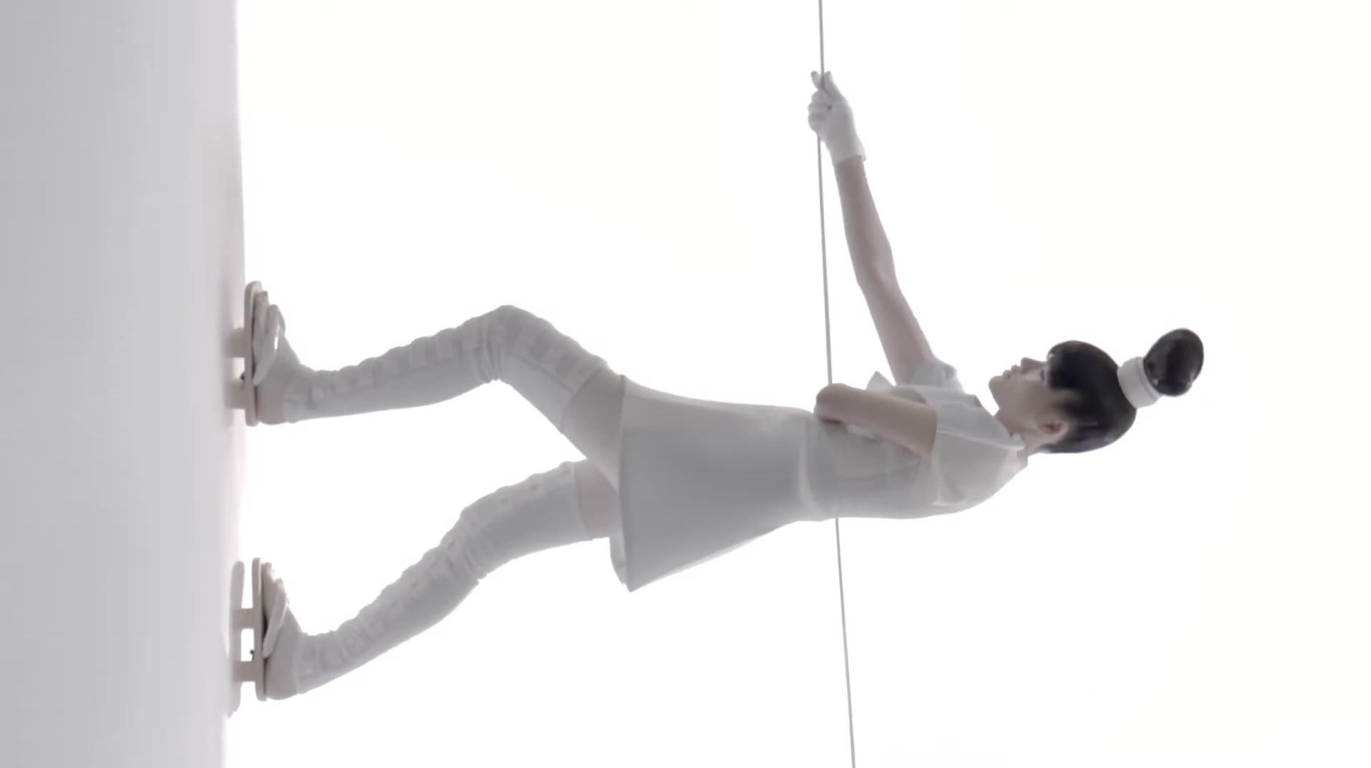 A figure in white, held on a single line.